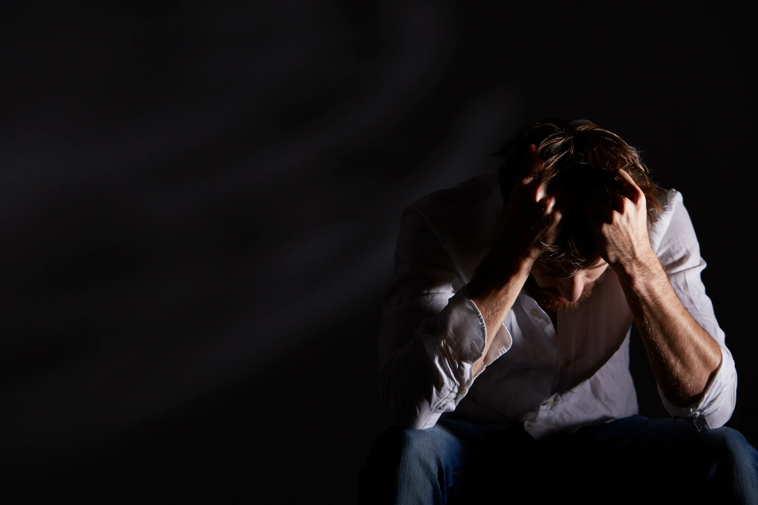 One person listening closely to another during a supportive conversation about suicide